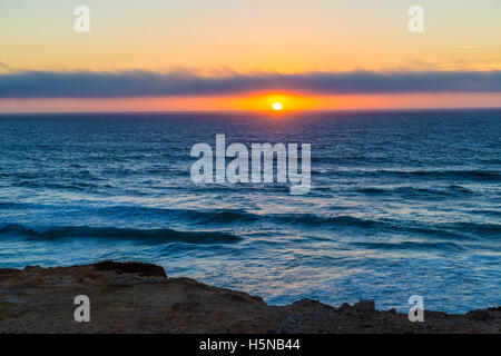 Cloudy sunset over ocean near Cascais, Portugal Stock Photo