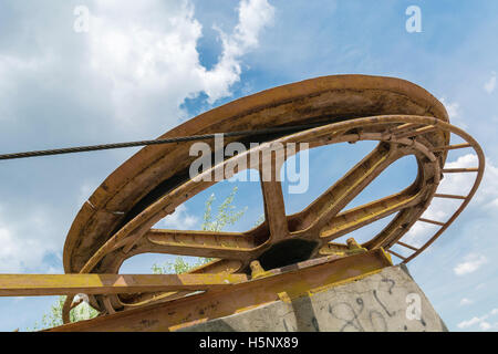 large rusty wheel rope pulley Stock Photo