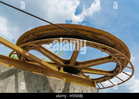 large rusty wheel rope pulley Stock Photo