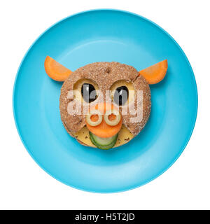 Pig made of bread and vegetables on plate Stock Photo