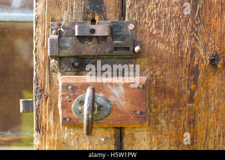 An old brown wooden door with an and old lock Stock Photo