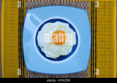 Directly Above Shot Of Sunny Side Up Egg In Blue Plate Stock Photo