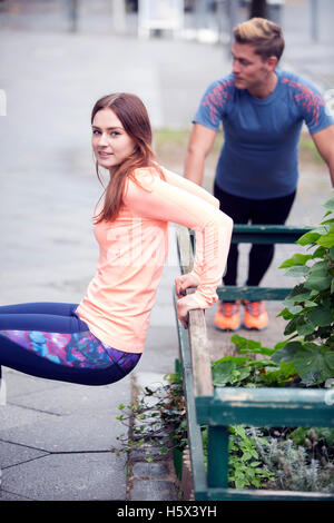young couple doing workout outdoors in the street Stock Photo