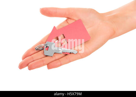 Hand holds key with a keychain in the shape of a house on a white background. Stock Photo