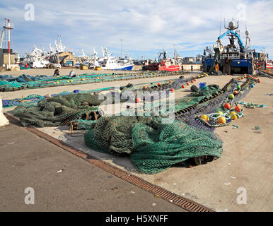 Mending fishing nets on the quayside at Fraserburgh, Aberdeenshire, Scotland, United Kingdom, UK. Stock Photo