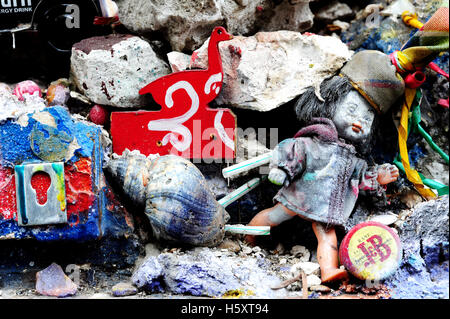 Toys and other small objects become an art installation on a wall in the Belleville district of Paris, France Stock Photo