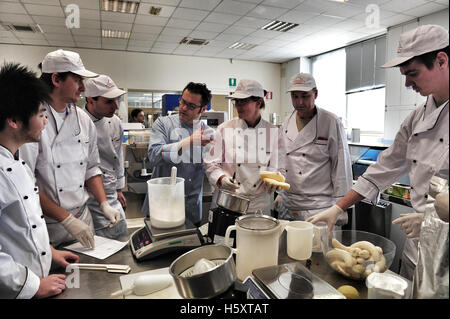 Maestro Palmiro Bruschi and his students during a practical lesson at the Carpigiani Gelato University in Italy Stock Photo
