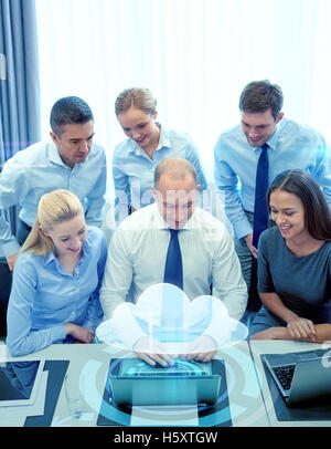 smiling business people with laptop in office Stock Photo