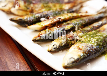 Plate on a table with Spanish roasted sardines Stock Photo