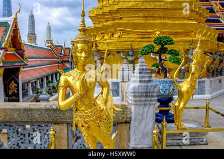 Golden Kinnari statue at Temple of Emerald Buddha (Wat Phra Kaew) in Grand Royal Palace. Half-bird, half-woman creature at south Stock Photo