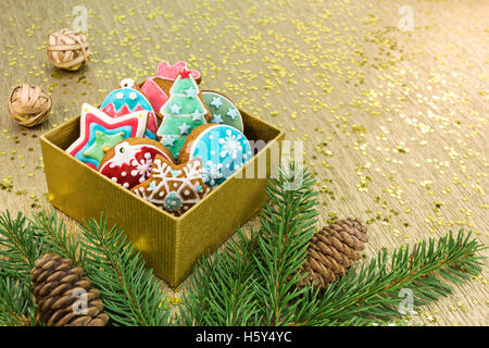 christmas background with gift box, gingerbread cookies and fir branches Stock Photo