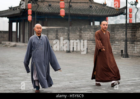 Monks walking in the ancient Xian City Wall Gate and Tower, Shaanxi, China Stock Photo