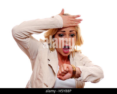 A attractive blond woman is surprised when she looks at her watch. Stock Photo