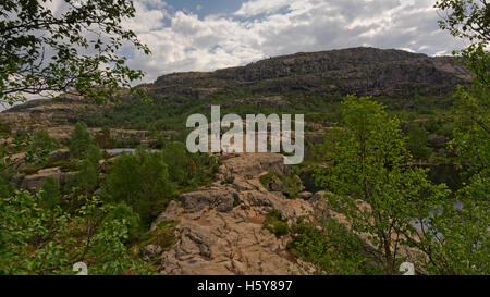 Small people hiking on a big mountain plateau in Rogaland, Norway Stock Photo