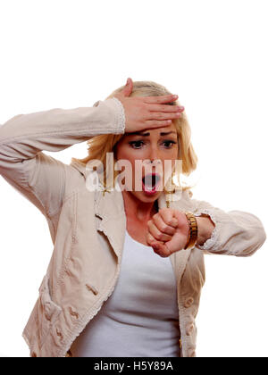 A woman is shocked when she looks at her watch. Stock Photo