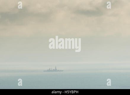 Dover Straits, UK. 21st October, 2016. A distant shot of HMS Duncan, a Royal Navy type 45 destroyer escorting the Russian ships passing through the Dover Straits at midday today on their way to Syria. Credit:  Stephen French/Alamy Live News Stock Photo