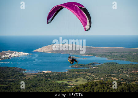 Monte Toro, Menorca, Spain. 21st Oct, 2016. A paraglider enjoys the Mediterranean autumn sun while he flies in front of the 'Monte Toro', the tallest hill of the island of Menorca, at the afternoon. Credit:  matthi/Alamy Live News Stock Photo