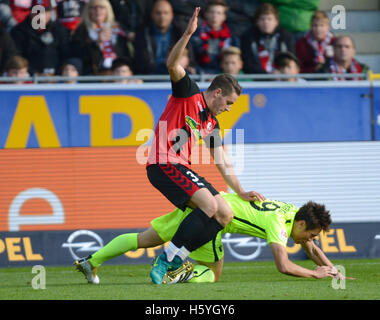 Freiburg's Christian Guenter (front) and Augsburg's Ja-Cheol Koo in action during the Bundesliga soccer match between SC Freiburg and FC Augsburg at Schwarzwald stadium in Freiburg im Breisgau, Germany, 22 October 2016. PHOTO: PATRICK SEEGER/dpa (EMBARGO CONDITIONS - ATTENTION: Due to the accreditation guidlines, the DFL only permits the publication and utilisation of up to 15 pictures per match on the internet and in online media during the match.) Stock Photo