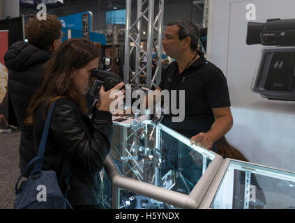 New York, USA. 22nd October, 2016. Visitors examine Hasselblad products during 2016 New York PhotoPlus Expo in Jacob Javits Convention Center Credit:  lev radin/Alamy Live News Stock Photo