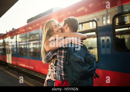 Beautiful couple hugging after long separation Stock Photo