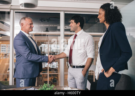 Shaking hands to a successful merger Stock Photo
