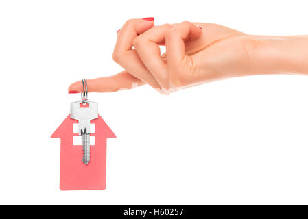 Hand holds key with a keychain in the shape of a house on a white background. Stock Photo