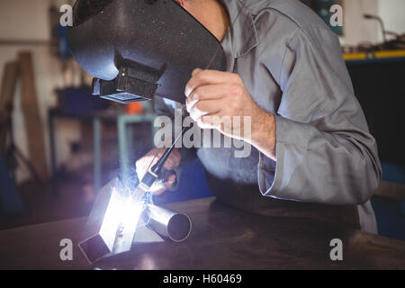 Welder working on a piece of metal Stock Photo