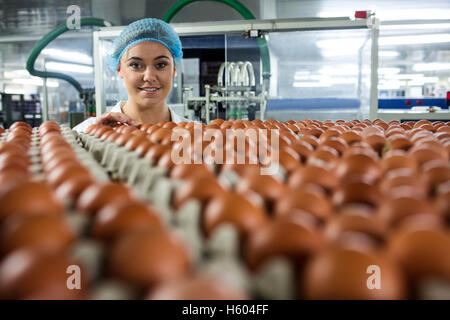 Portrait of female staff examine eggs Stock Photo