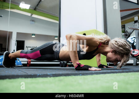 Woman performing push-up exercise Stock Photo