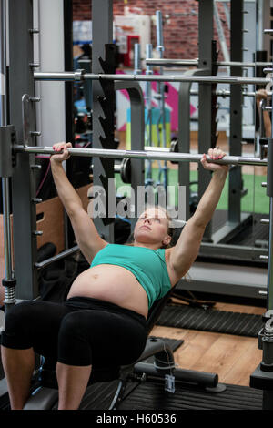 Pregnant woman lifting weights Stock Photo