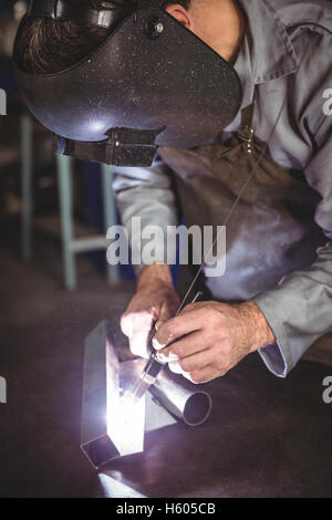Welder working on a piece of metal Stock Photo