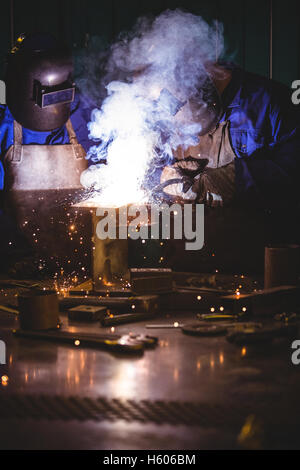 Welders welding a metal Stock Photo