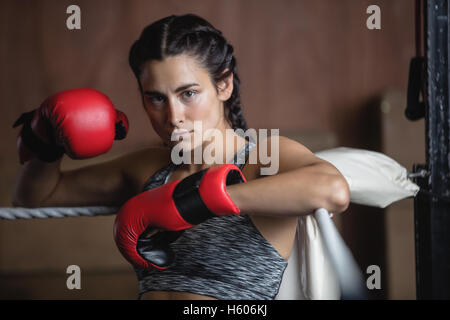 Portrait of tired female boxer in boxing gloves Stock Photo