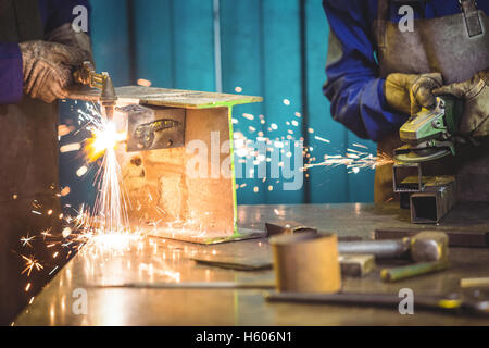 Mid-section of welders working at work shop Stock Photo