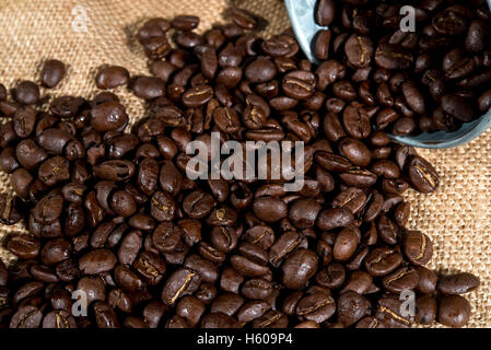 Arabica coffee beans in small tank on sack backgrounds Stock Photo