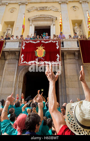 Enxaneta´child who rises to the top of the human tower celebrating a great success in the town hall balcony. Castellers de Sant Stock Photo