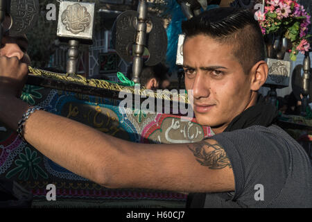 9 Muharram (Tasua), Bijar, Man Holding Alam Stock Photo