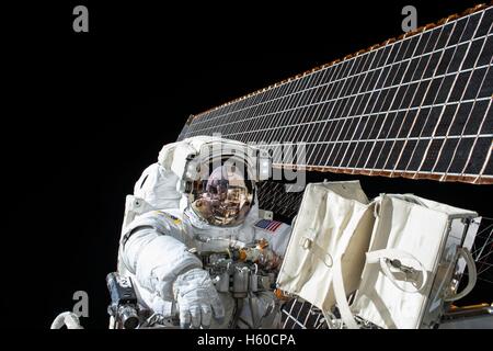 NASA International Space Station Expedition 45 astronaut American Scott Kelly does maintenance on the outside of the ISS during an extravehicular activity spacewalk November 6, 2015 while in Earth orbit. Stock Photo