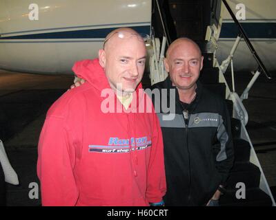 NASA International Space Station Expedition 26 astronaut Scott Kelly (left) is reunited with twin brother, astronaut Mark Kelly, after landing the Soyuz TMA-01M spacecraft in Kazakhstan at the Ellington Field Joint Reserve Base March 17, 2010 in Houston, Texas. Stock Photo