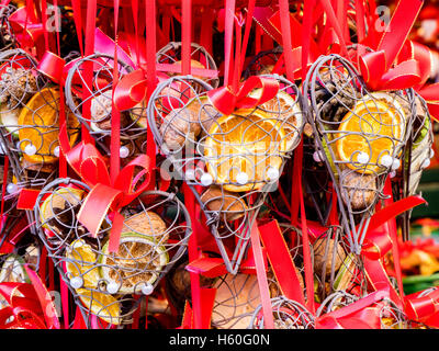 Many gifts hanged in a market stall of a Christmas little market in Austria, decorated with dried fruits. Stock Photo