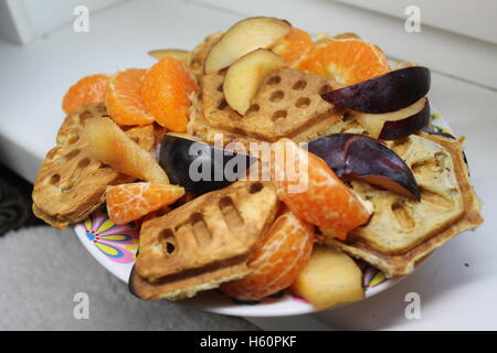 colorful salad from vegetarian crust cookies and slices of ripe juicy garden fruits Stock Photo