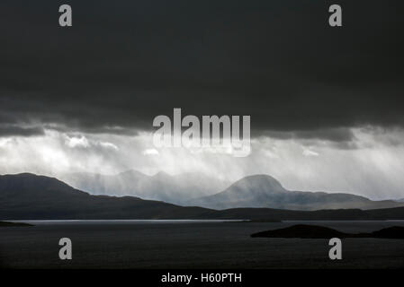 Black stormy sky and downpour during rain storm over desolate wilderness of Coigach, Wester Ross,  Western Highlands of Scotland Stock Photo
