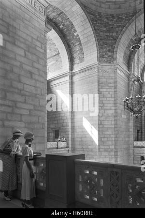 Two Women in Shadow on Rotunda Balcony, State Capitol Building, Lincoln, Nebraska, USA, by Samuel H. Gottscho, June 1934 Stock Photo