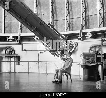 Professor H.E. Burton Looking through Telescope, U.S Naval Observatory, Washington DC, USA, National Photo Company, August 1929 Stock Photo