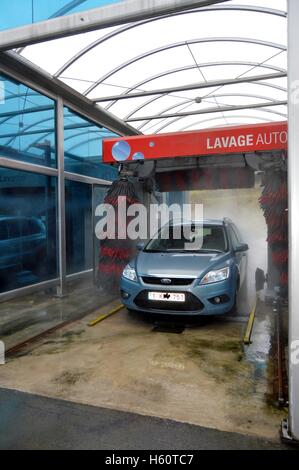 Car in a center of automatic wash with rollers. Stock Photo