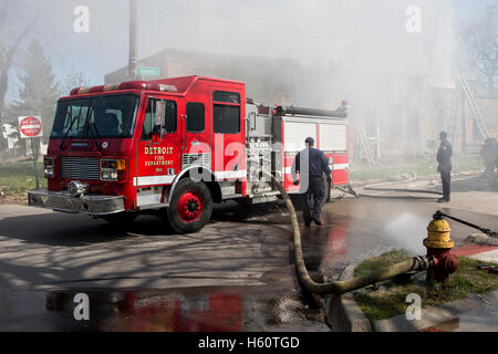 Fire engine pumper hooked to fire hydrant at house fire, Detroit Stock