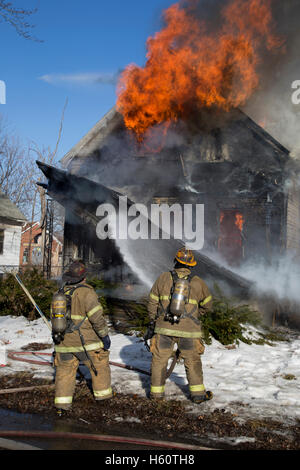 Firefighters extinguishing house fire, Detroit, Michigan USA Stock Photo