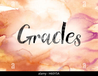 The word 'Grades' painted in black ink over a colorful watercolor washed background concept and theme. Stock Photo