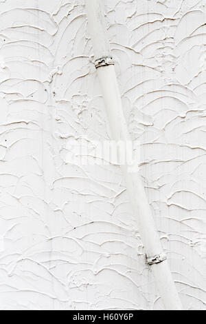 Part of a house with rain gutter on white wall Stock Photo