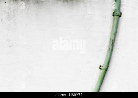 Part of a house with rain gutter on white wall Stock Photo